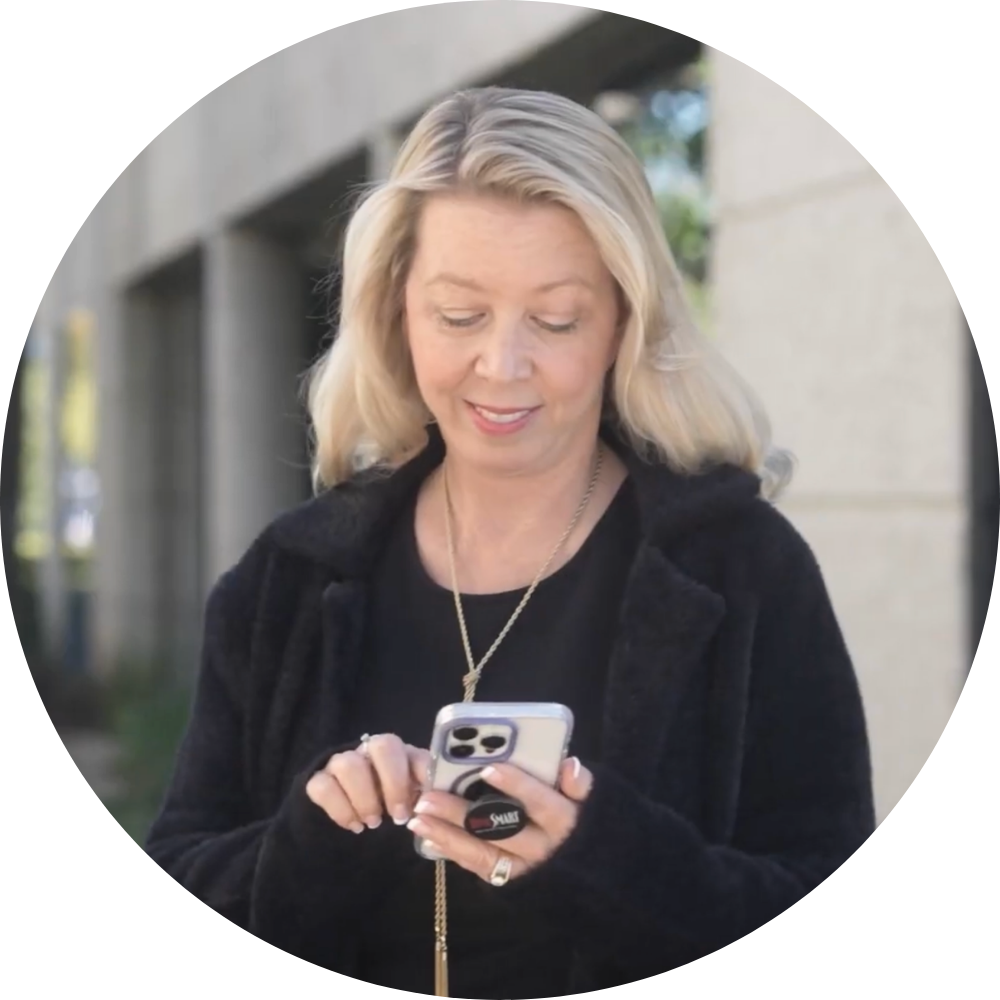 Sarah Piazza looking at the phone while smiling