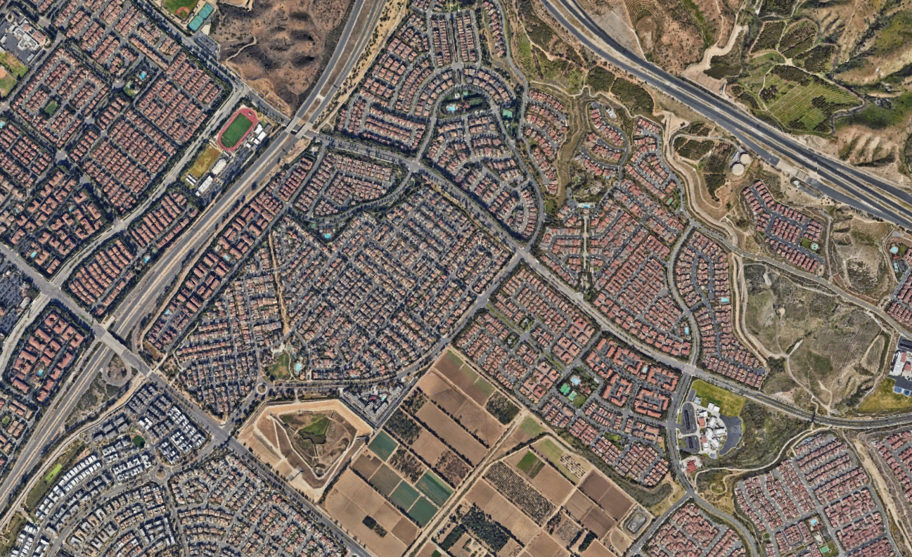 Aerial view of neighborhood houses and streets.