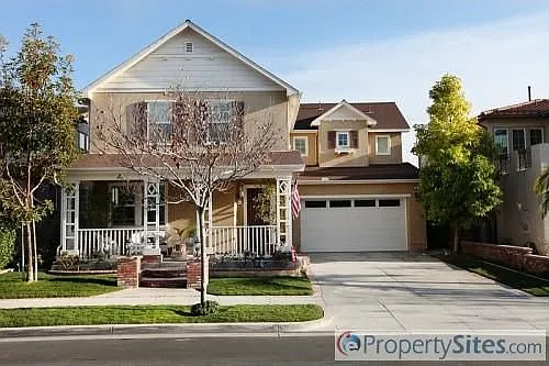 California real estate house with porch, garage, trees, and landscaping.