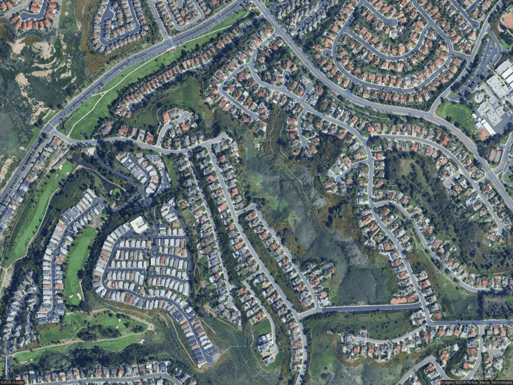 California real estate houses in suburban neighborhood with roads and green spaces